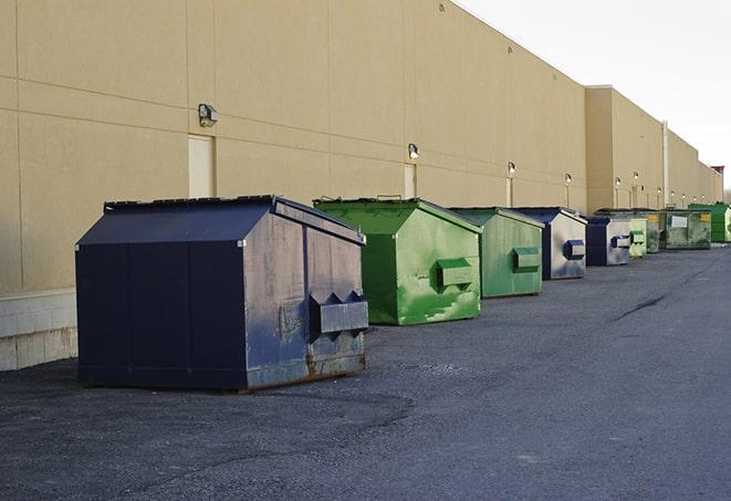 a row of industrial dumpsters at a construction site in Converse TX